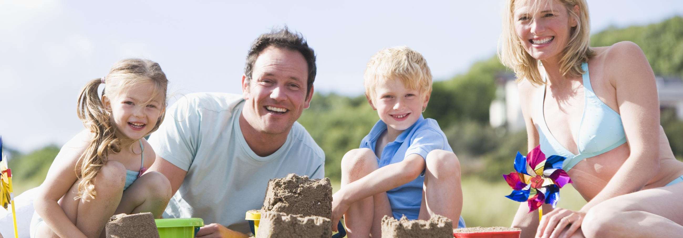 family making sandcastles on beach