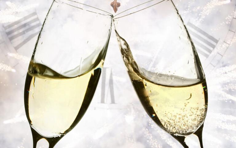 Champagne Glasses with Fireworks & Clock in the background