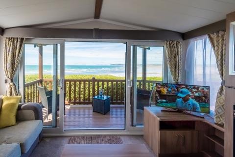 Lounge Area and Outside Decking Overlooking the Sea of a Caravan Holiday Home
