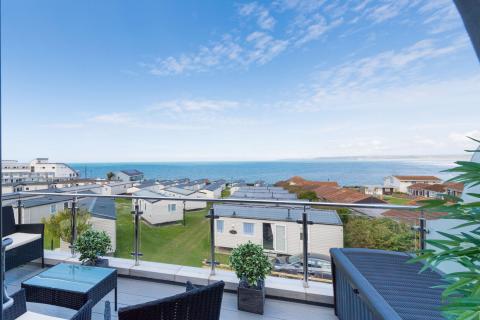 View from an Apartment Outside Decking Looking out over other Accommodation and the Sea