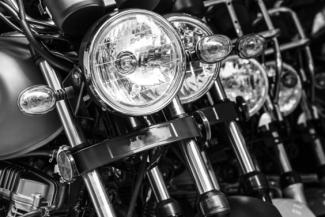 Black & White Photograpgh of a row of Motorbike Headlamps
