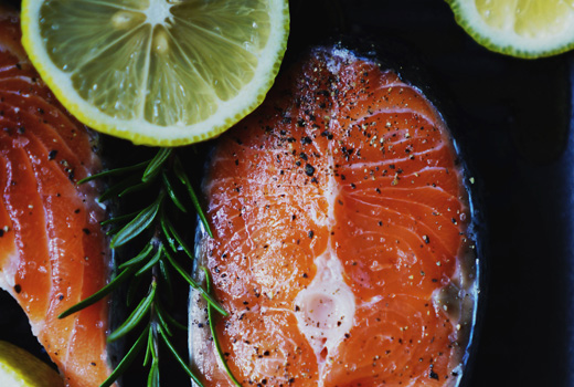 Fresh fish and lemon and limes with some herbs
