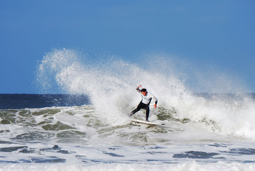 A Surfer Riding a Wave at Putsborough Beach in North Devon