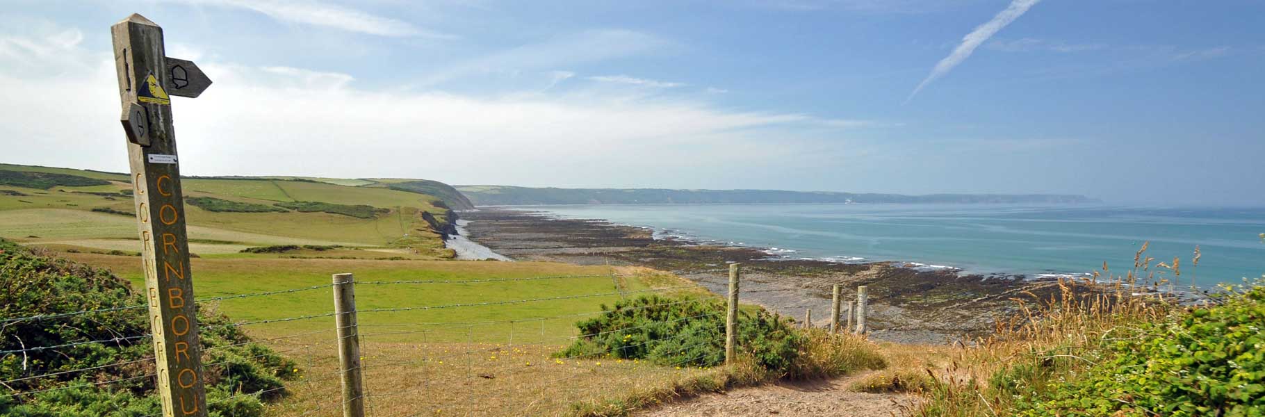 Sign Post on a Coastal Path with views of the North Devon Coastline and Atlantic Ocean