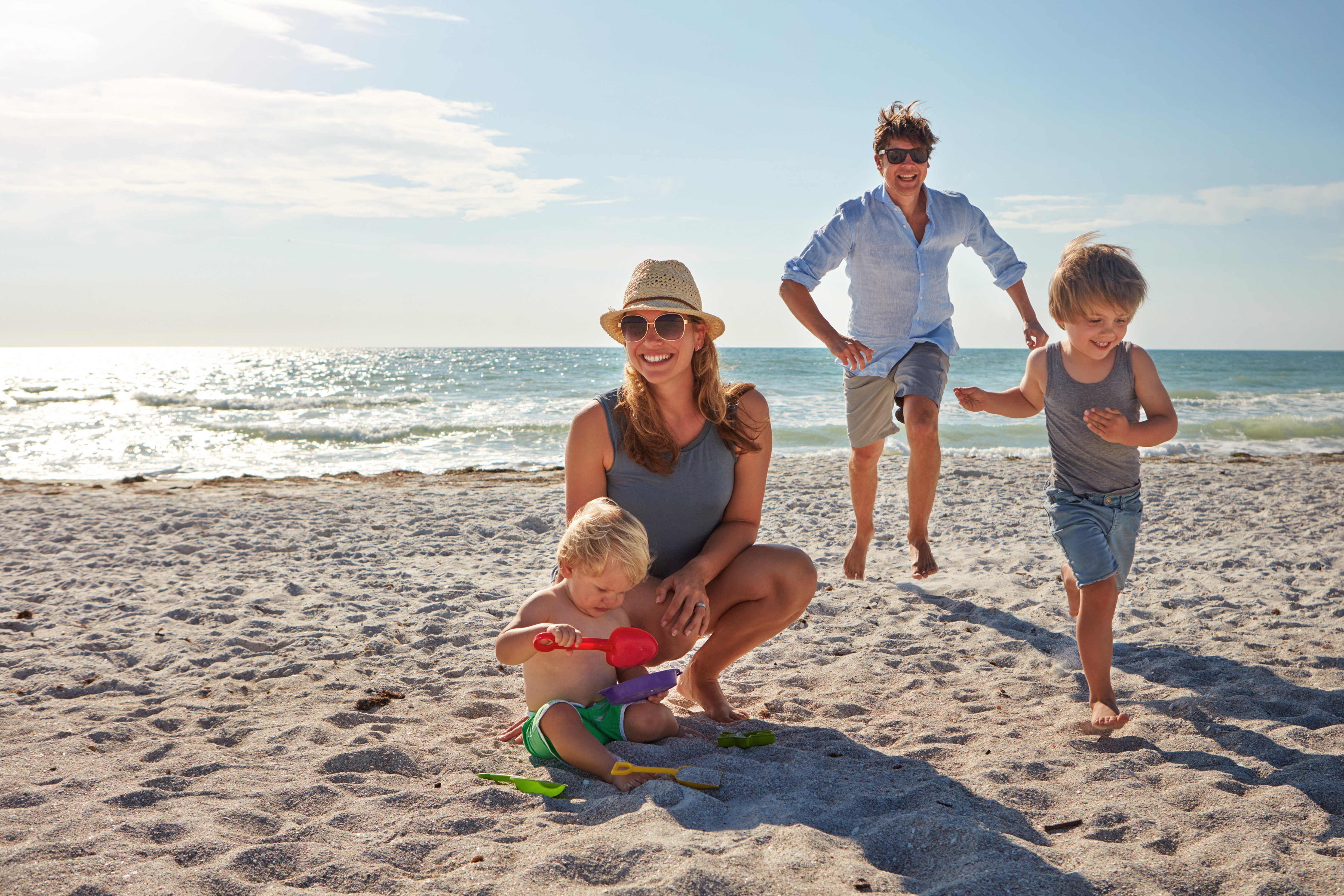 Family of four on holiday on beach