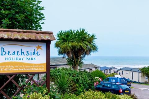Holiday Park sign, and homes with a Beach in the background